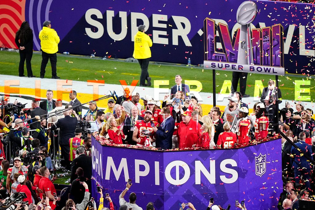 Kansas City Chiefs celebrating Super Bowl LVIII victory at Allegiant Stadium with Andy Reid and Travis Kelce holding the Lombardi Trophy - Live Sports Event Photography by Louis Grasse for Fifty Frame Creatives.