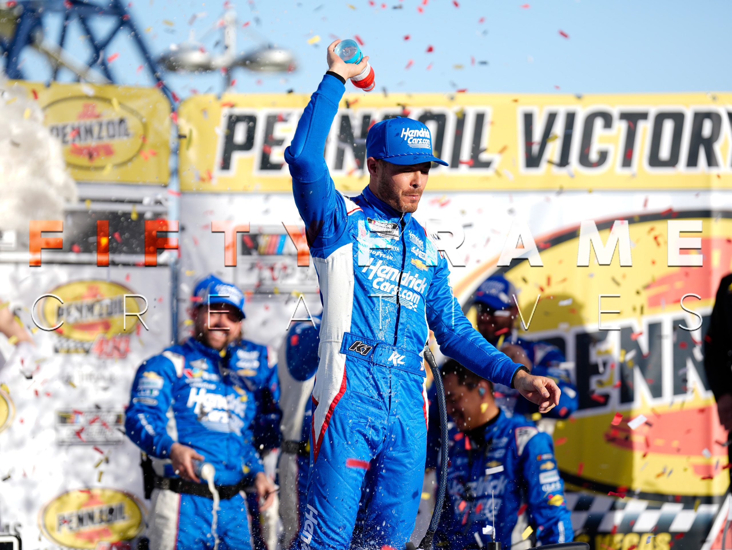 NASCAR Cup Series Champion Kyle Larson celebrating in victory lane covered in confetti after a win at Las Vegas Motor Speedway - Professional Motorsports Photography by Louis Grasse for Fifty Frame Creatives.